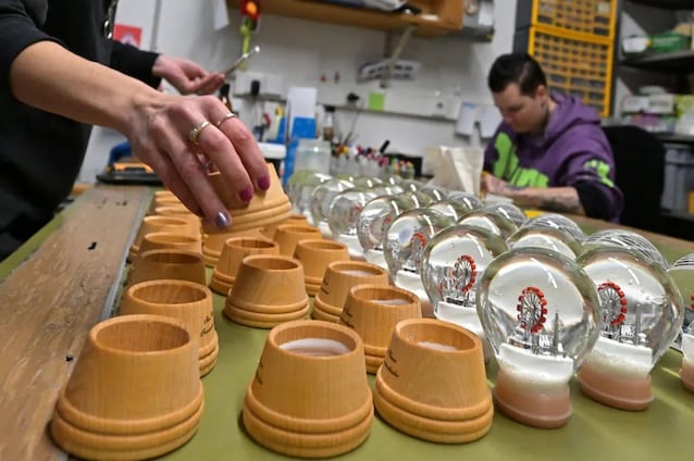 Employees of the Original Vienna Snow Globe Factory assemble and paint different snow globes. Joe Klamar/AFP via Getty Images