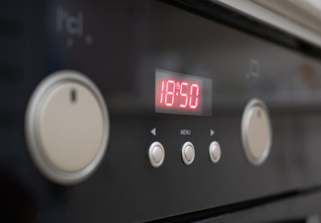 The oven clock tells the wrong time because it relies on alternating current cycles