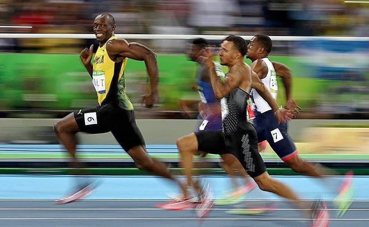 The physics behind the 100 meter flat: how temperature and humidity can be worth a tenth of a second